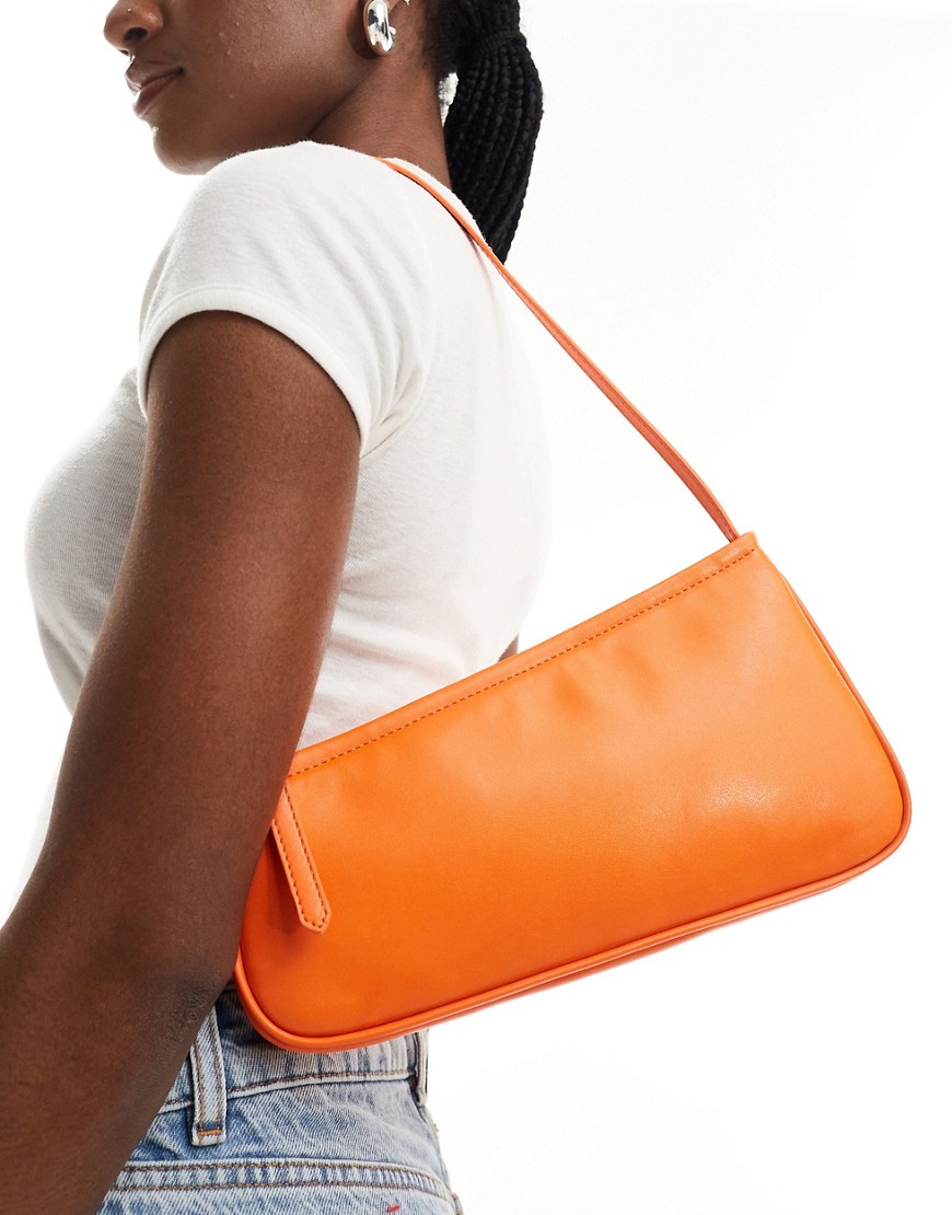 ASOS DESIGN asymmetric buckle shoulder bag in orange