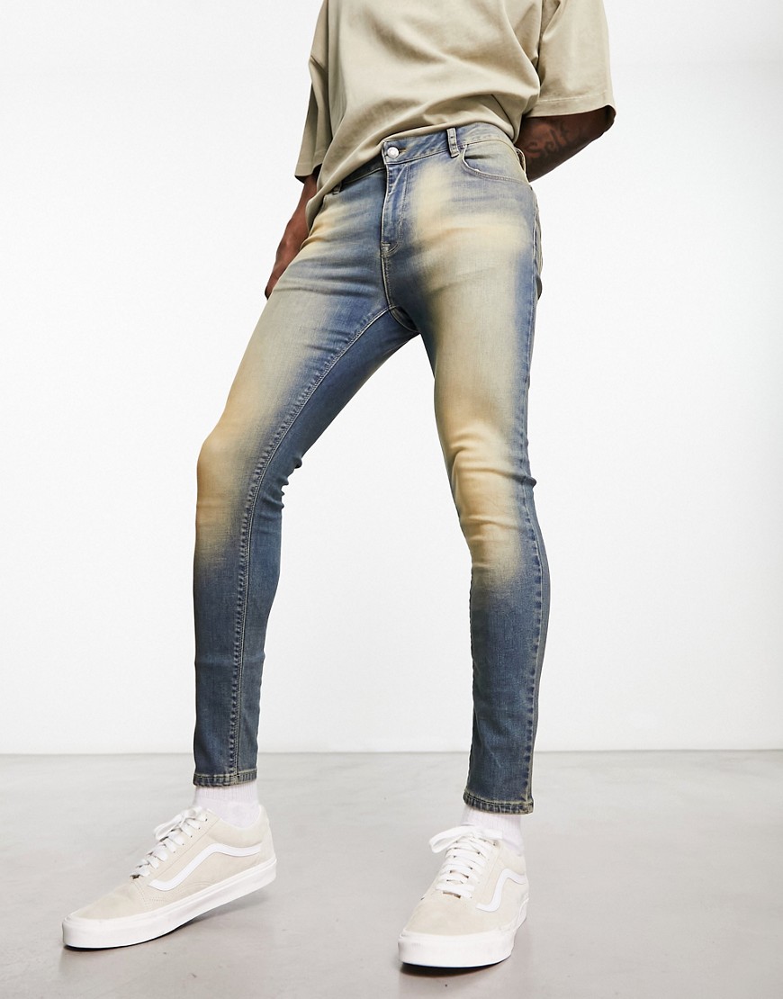 ASOS DESIGN spray on jeans with power stretch in tinted blue wash